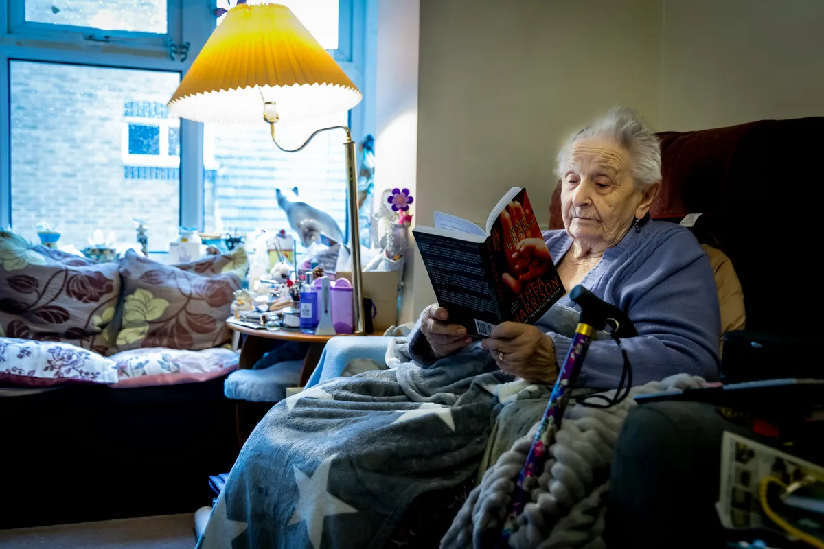 Elderly woman enjoying reading at home