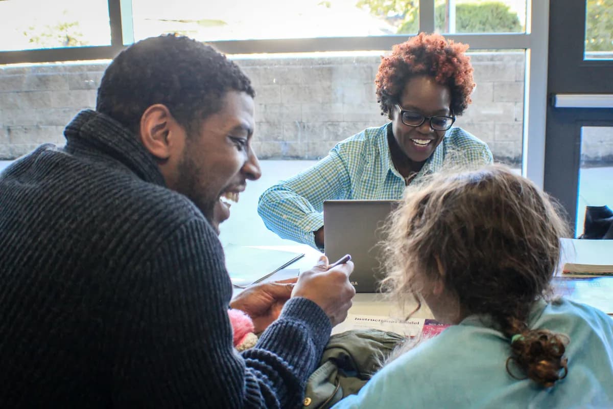 care home staff discussing and laughing in a meeting