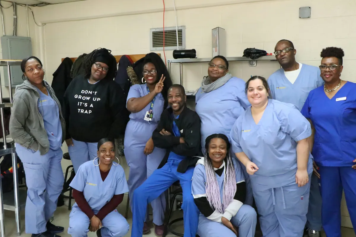 group of care workers pose for a photo