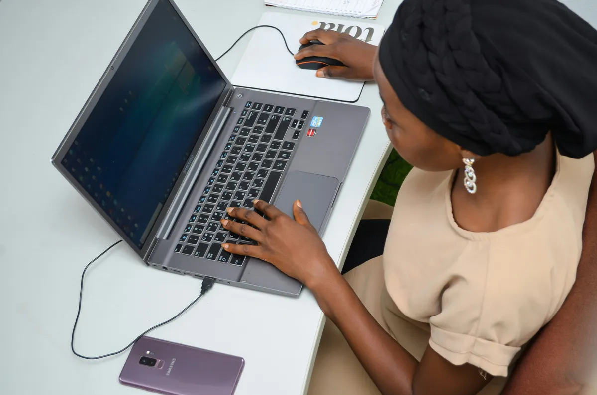 a premier care admin staff working doing paperwork on her laptop